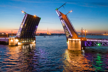 Fototapeta na wymiar White nights in Saint-Petersburg - the opening of the Palace drawbridge, a view of the Peter and Paul Cathedral