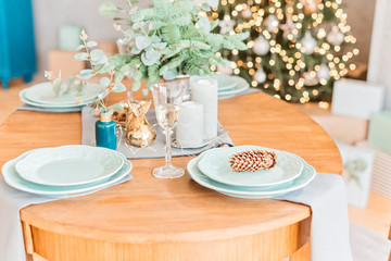 Christmas wooden table, a pine on white plate, a glass of champagne,  table setting
