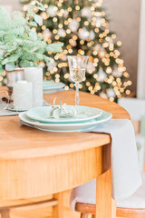Christmas wooden table, a glass of champagne, table setting