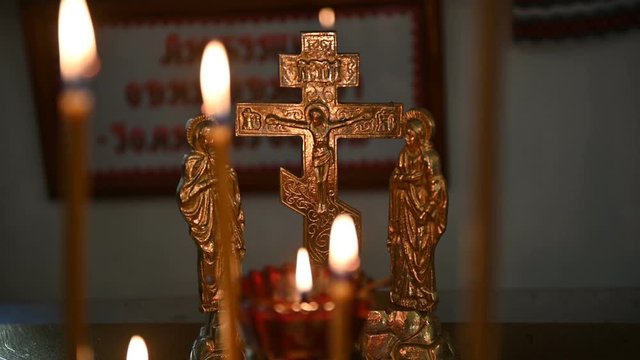 burning candles on a candlestick at the empty orthodox church