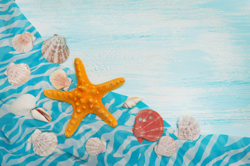 Fototapeta na wymiar Sea background with blue wood, starfish, shells