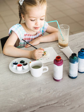 Girl drawing on macrons