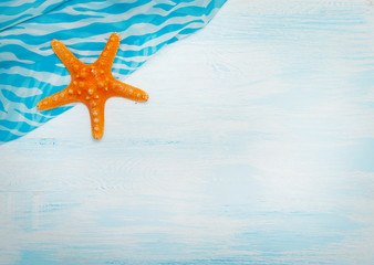 Fototapeta na wymiar Sea background with blue wood, rope, starfish