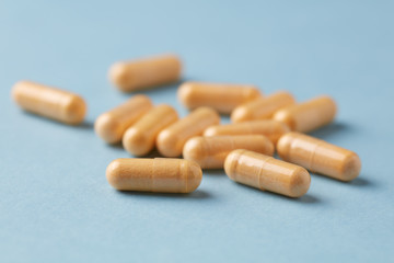 Coenzyme Q10 capsules. Dietary supplements. Bright paper background. Close up. 