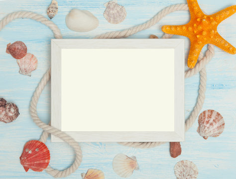 Sea background with frame and blue painted wood, rope, starfish, shells
