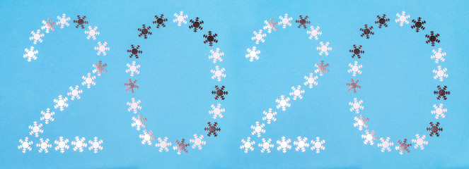 Figures 2020 made of snowflakes on a blue background. Сard for the New Year.