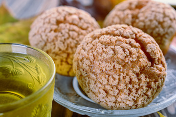 Delicious lush buns and a cup of green tea nearby cooked for breakfast