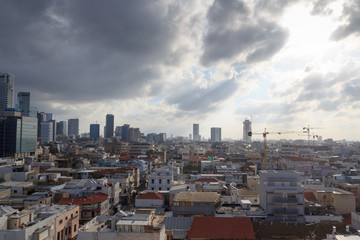 Skyline panorama of city Tel Aviv with some dark storm clouds and urban skyscrapers in the morning, Israel