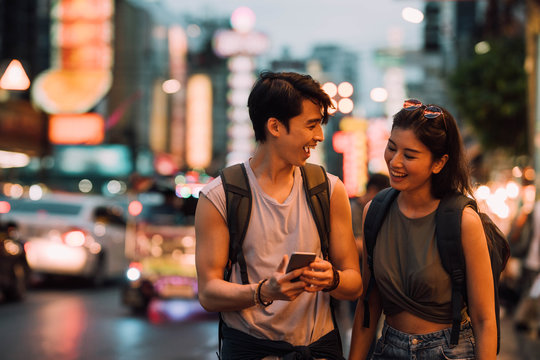 Backpackers Using Cell Phone