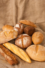 Several types of bread on burlap background