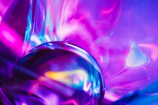 Abstract shots of crystal ball on light violet colorful backdrop