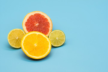 various citrus slices of orange lime lemon and grapefruit arranged on colorful background abstract wallpaper with copy space