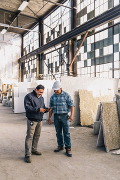 Workers Looking at Tablet Computer