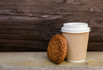Disposable glass with white lid and cookies