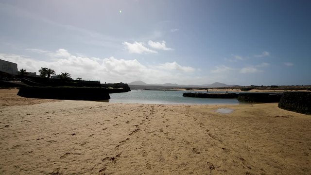 Private sandy beach on the island of Lanzarote. Coming to the water along the sandy beach.