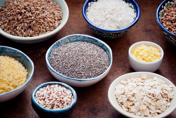 Various organic cereals and grains in different bowls