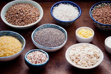 Various organic cereals and grains in different bowls