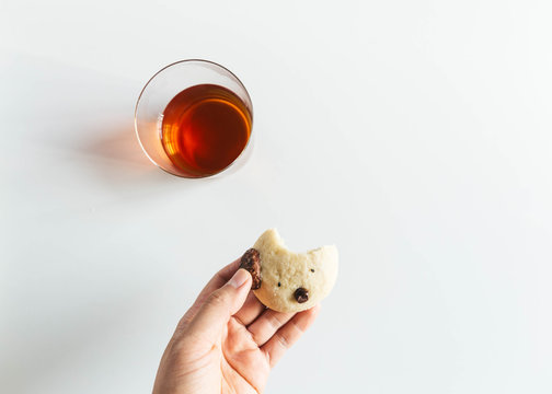 Hand holding cookie that has been bitten into