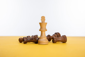 Obraz na płótnie Canvas chess figures on yellow surface isolated on white
