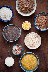 Various organic cereals and grains in different bowls