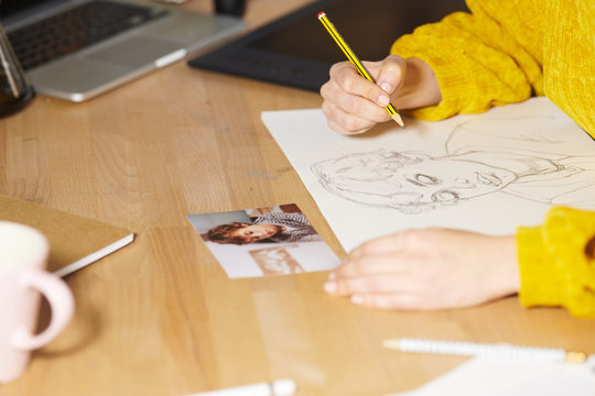 Woman drawing with pencil on paper