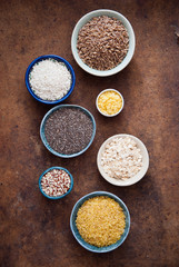 Various organic cereals and grains in different bowls