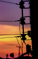 Power pole silhouette with sunset in the background, Guaratiba Rock, Rio de Janeiro, Brazil