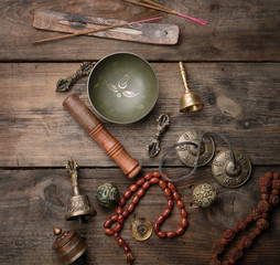 Copper singing bowl, prayer beads, prayer drum and other Tibetan religious objects for meditation...