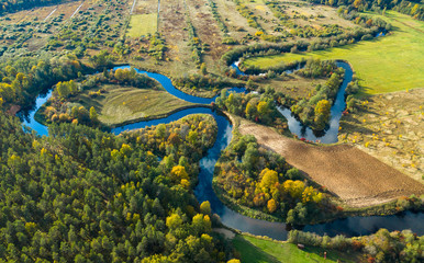 Latvian autumn nature. VIew from the top. Forest and river Jugla.