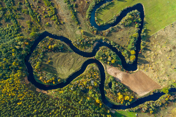 Latvian autumn nature. VIew from the top. Forest and river Jugla.