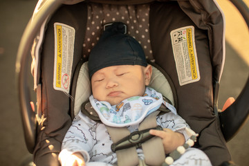 Cute little baby sleeping in infant car seat
