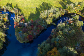 Latvian autumn nature. VIew from the top. Forest and river Jugla.