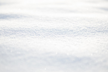 White snow wavy surface close up and flakes background