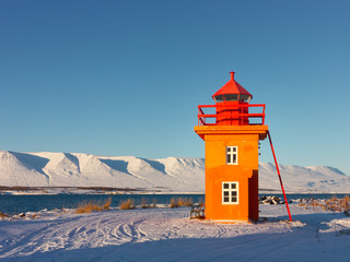 Orange lighthouse near the city of Akureyri in northern Iceland