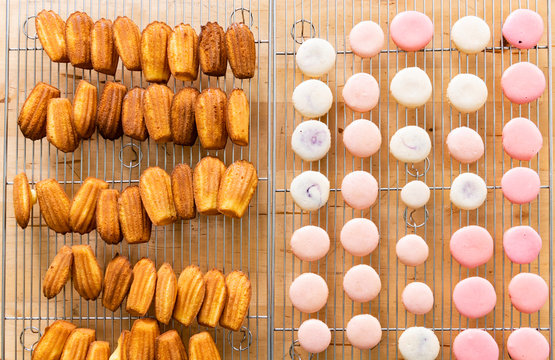 Madeleine and macaron fresh out of the oven on cooling rack