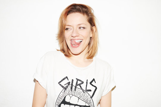 Flirty contemporary girl showing tongue