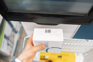 close up consumer check the price in the store using rfid scanner