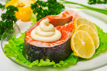 Salmon fish with lemon on lettuce