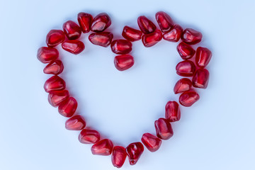 Heart shaped pomegranate on a light background