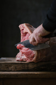 Hand cutting meat with knife