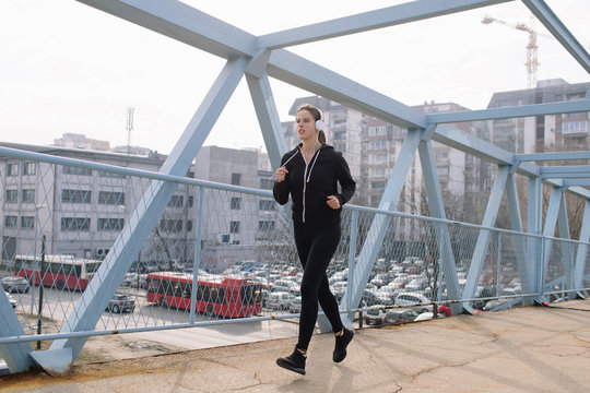 Woman running on the bridge