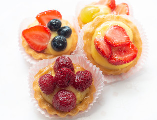 cupcakes with fresh seasonal fruit. Fresh fruit tart with cream and jelly