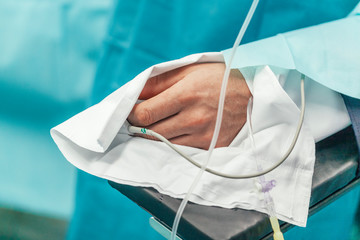 Hand of patient during a surgical intervention