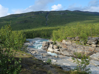 Fototapeta na wymiar Lapland nature landscape. Abisko blue river canyon carved in the limestone and granite by glacial water. Abisko National Park, Lapland, Northern Sweden close to Abisko Fjallstation at the start of
