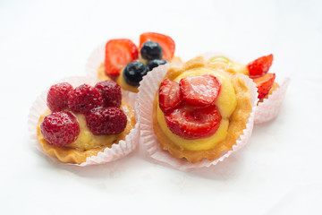 cupcakes with fresh seasonal fruit. Fresh fruit tart with cream and jelly