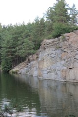 Red granite canyon with pine forest and lake