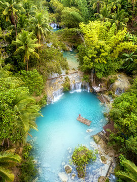 Woman exploring Cambugahay Falls in Siquijor, Philippines