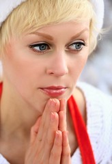 woman with red Christmas hat on and smiling stock photo	