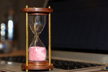 hourglass on black computer background