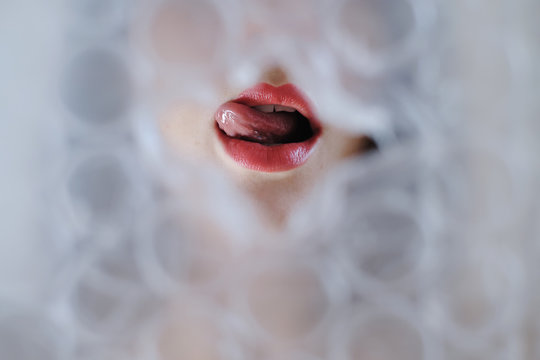 Woman face trough bubble wrap